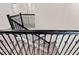 Stylish staircase featuring dark wood railing, wrought iron spindles, and carpeted steps at 3138 Dark Sky Dr, St Cloud, FL 34773