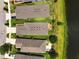 Aerial view of the home showcases backyard lake views, brick patio, and well-maintained landscaping at 3428 Sagebrush St, St Cloud, FL 34773