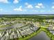Expansive aerial view featuring homes near serene lakes and lush greenery, showcasing a vibrant and peaceful community at 3428 Sagebrush St, St Cloud, FL 34773