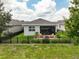 Lovely backyard features a patio with outdoor furniture, surrounded by lush greenery and a black fence at 3428 Sagebrush St, St Cloud, FL 34773