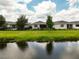 Picturesque backyard view overlooking a tranquil pond, showcasing a relaxing waterfront living experience at 3428 Sagebrush St, St Cloud, FL 34773
