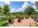 Beautiful backyard with brick patio, lush lawn and peaceful lake views, perfect for relaxation at 3428 Sagebrush St, St Cloud, FL 34773