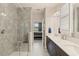 Stylish bathroom with a glass-enclosed shower, double vanity, and a view into the bedroom from the ensuite at 3428 Sagebrush St, St Cloud, FL 34773