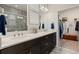 Modern bathroom with double sinks, quartz counters, and a separate walk-in closet for ample storage at 3428 Sagebrush St, St Cloud, FL 34773