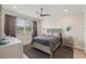 Comfortable bedroom featuring a ceiling fan, large window for natural light, and a stylish gray color palette at 3428 Sagebrush St, St Cloud, FL 34773