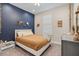 Charming bedroom with coastal-themed decorations, a comfortable bed, and a window with natural light at 3428 Sagebrush St, St Cloud, FL 34773