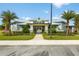 Exterior shot of the modern community building featuring lush landscaping and sidewalks at 3428 Sagebrush St, St Cloud, FL 34773