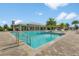 Large community pool with a separate wading area, sun loungers and palm trees on a sunny day at 3428 Sagebrush St, St Cloud, FL 34773