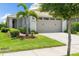 Charming single-Gathering home featuring a manicured lawn, mature landscaping, and a two-car garage with modern accents at 3428 Sagebrush St, St Cloud, FL 34773