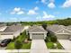 Inviting single-story home showcasing a pristine lawn, two-car garage, and serene pond views at 3428 Sagebrush St, St Cloud, FL 34773