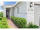 Inviting front entrance with stone pillar, red brick walkway, and lush landscaping leading to the front door at 3428 Sagebrush St, St Cloud, FL 34773