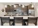 Stylish kitchen featuring stainless appliances, a center island with seating, and elegant pendant lighting at 3428 Sagebrush St, St Cloud, FL 34773