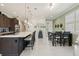 Open-concept kitchen and dining area with stainless appliances, island seating, and natural light at 3428 Sagebrush St, St Cloud, FL 34773