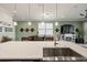 Open layout features a modern kitchen with island seating flowing into the living area, creating a seamless living space at 3428 Sagebrush St, St Cloud, FL 34773