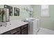 Well-equipped laundry room featuring a washer and dryer, complemented by sleek cabinetry and countertops at 3428 Sagebrush St, St Cloud, FL 34773