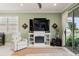Cozy living room with a fireplace, comfortable recliner, and sliding glass doors to outdoor living at 3428 Sagebrush St, St Cloud, FL 34773
