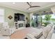 Inviting living room with a fireplace, large sliding glass doors leading to a patio, and a serene lake view at 3428 Sagebrush St, St Cloud, FL 34773