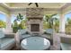 Inviting outdoor lounge area with comfortable seating and a striking stone fireplace at 3428 Sagebrush St, St Cloud, FL 34773