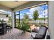 Enjoy serene water views from this screened patio, complete with stylish seating and brick flooring at 3428 Sagebrush St, St Cloud, FL 34773