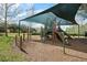 Community playground with multiple slides and climbing structures with shaded canopy overhead at 3428 Sagebrush St, St Cloud, FL 34773