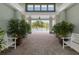 Elegant pool entrance framed by lush plants and stylish benches, enhancing the welcoming atmosphere at 3428 Sagebrush St, St Cloud, FL 34773