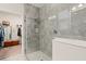 Modern shower with rainfall shower head, glass enclosure, and stone tile offers a spa-like experience at 3428 Sagebrush St, St Cloud, FL 34773