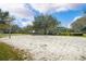 Community volleyball court with sand and green vegetation at 3428 Sagebrush St, St Cloud, FL 34773