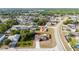 An aerial view shows a charming single-Gathering home with a solar-paneled roof and a relaxing pool, bordered by a red fence at 402 Ohio Way, Kissimmee, FL 34759