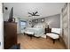 Serene bedroom features a ceiling fan, wood floors, and large bed, with tasteful decor at 402 Ohio Way, Kissimmee, FL 34759
