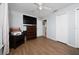 This bedroom features a ceiling fan, wood-look flooring, and closet storage space at 402 Ohio Way, Kissimmee, FL 34759