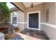 Inviting front porch with decorative tile, a stylish front door, and attractive landscaping at 402 Ohio Way, Kissimmee, FL 34759