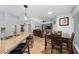 Open-concept living area with granite counters, island seating, and living room view at 402 Ohio Way, Kissimmee, FL 34759