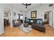 Bright living room with a comfortable sofa, artwork, and access to an outdoor patio at 402 Ohio Way, Kissimmee, FL 34759