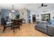 Open concept living room with dining area features stylish decor and natural light from sliding glass doors at 402 Ohio Way, Kissimmee, FL 34759