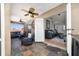 A covered outdoor patio featuring cozy seating and ceiling fans, accessible from the main living area at 402 Ohio Way, Kissimmee, FL 34759