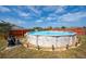 This backyard features an above ground pool and landscaped yard at 402 Ohio Way, Kissimmee, FL 34759