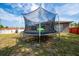 Backyard trampoline with safety net at 402 Ohio Way, Kissimmee, FL 34759