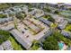 An aerial view of a community showcasing building exteriors, parking, playground, tennis courts, and partial pool view at 4403 S Semoran Blvd # 2, Orlando, FL 32822