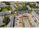 An aerial view of a community showcasing building exteriors, green spaces, parking, playground, and tennis courts at 4403 S Semoran Blvd # 2, Orlando, FL 32822