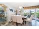 Formal dining room with elegant chandelier, decorative china cabinet, and sunlit windows at 4403 S Semoran Blvd # 2, Orlando, FL 32822