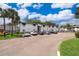 Exterior view of white residential building with neatly parked cars and green grass at 4403 S Semoran Blvd # 2, Orlando, FL 32822
