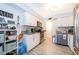 Bright kitchen featuring white cabinets, modern appliances, and stylish wood-look tile flooring at 4403 S Semoran Blvd # 2, Orlando, FL 32822