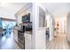 Galley kitchen featuring stainless steel appliances, white cabinets, and wood-look tile flooring at 4403 S Semoran Blvd # 2, Orlando, FL 32822