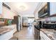 Spacious kitchen with stainless steel appliances, granite countertops, and an open view to the dining area at 4403 S Semoran Blvd # 2, Orlando, FL 32822