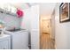 Convenient laundry area with modern washer and dryer units, and a hallway leading to front door at 4403 S Semoran Blvd # 2, Orlando, FL 32822