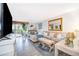 Bright living room with comfortable seating, stylish decor, and sliding glass door to the lanai at 4403 S Semoran Blvd # 2, Orlando, FL 32822