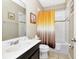 This bathroom includes a shower-tub combination and vanity for practical and stylish living at 4416 Acorn Ct, Davenport, FL 33837