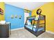 This ' bedroom showcases a playful Minions theme with a bunk bed and vibrant colors at 4416 Acorn Ct, Davenport, FL 33837