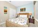 This is a cozy bedroom featuring a Queen-sized bed, warm lighting, and unique artwork at 4416 Acorn Ct, Davenport, FL 33837