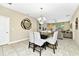 Cozy dining room with a modern chandelier, a large dining table, and a view of the living area at 4416 Acorn Ct, Davenport, FL 33837